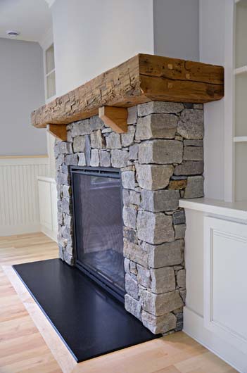 Greg Fitzpatrick Inc - Custom Home Builder - Stone Fireplace with Barn Beam Mantel